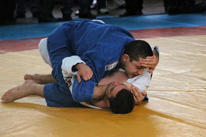 Two Brazilian Jiu-Jitsu practitioners grappling on the mat