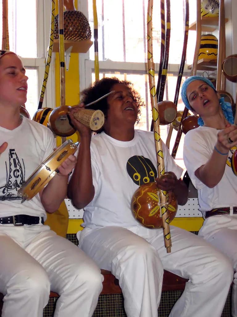 Capoeira Angola players in a low, grounded stance
