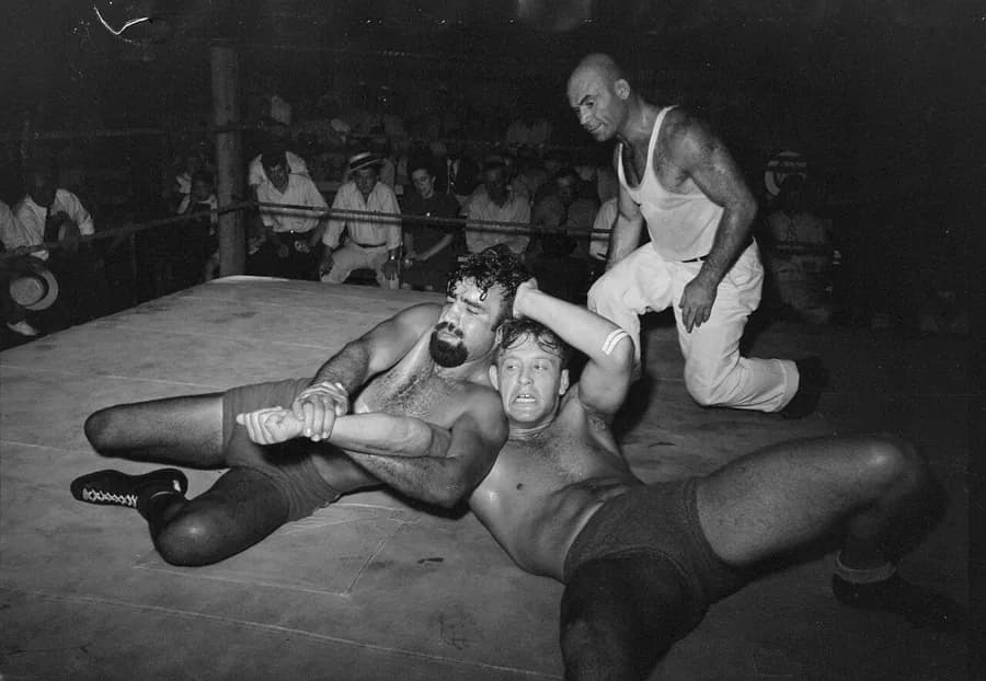 Catch wrestler applying top control and a submission ride