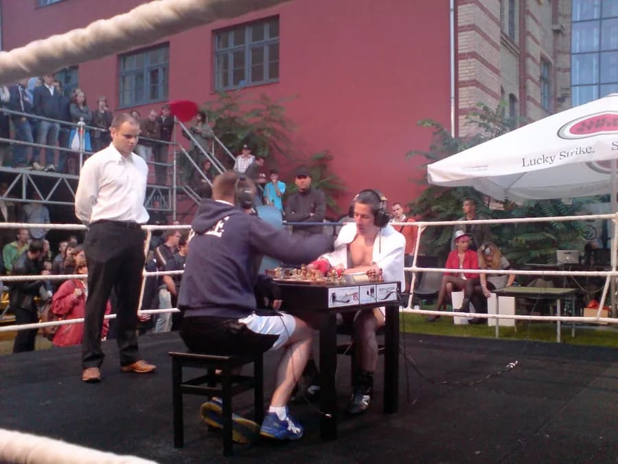 Chess boxer at the board between boxing rounds