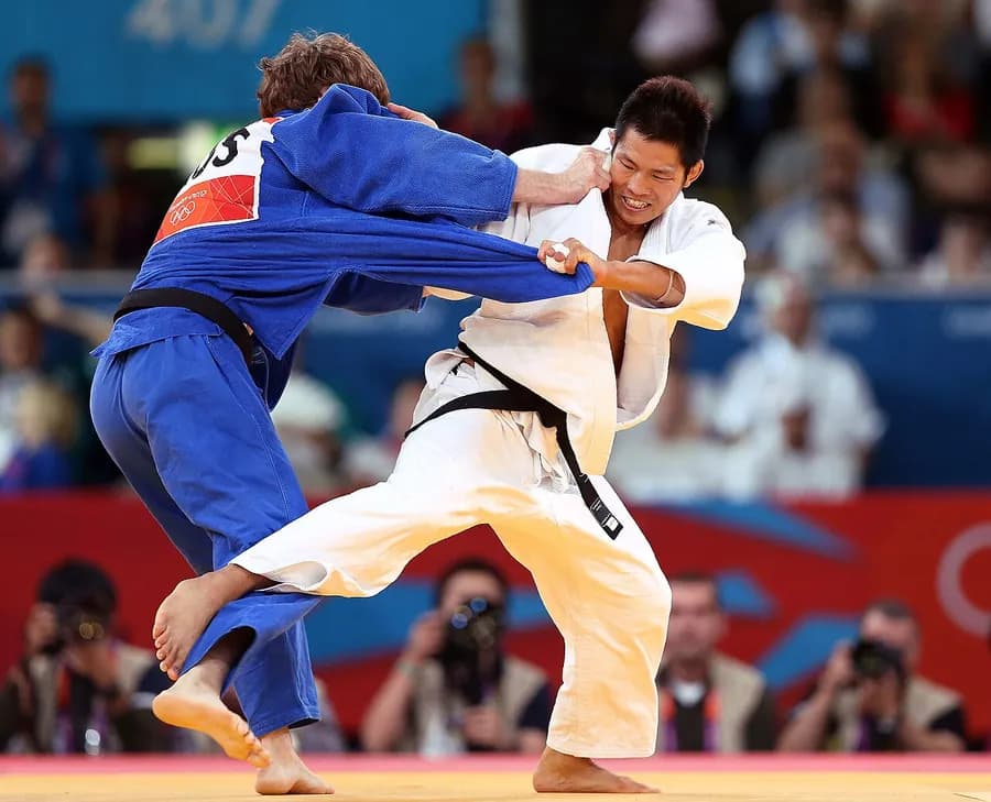 Judoka completing a throw during a match