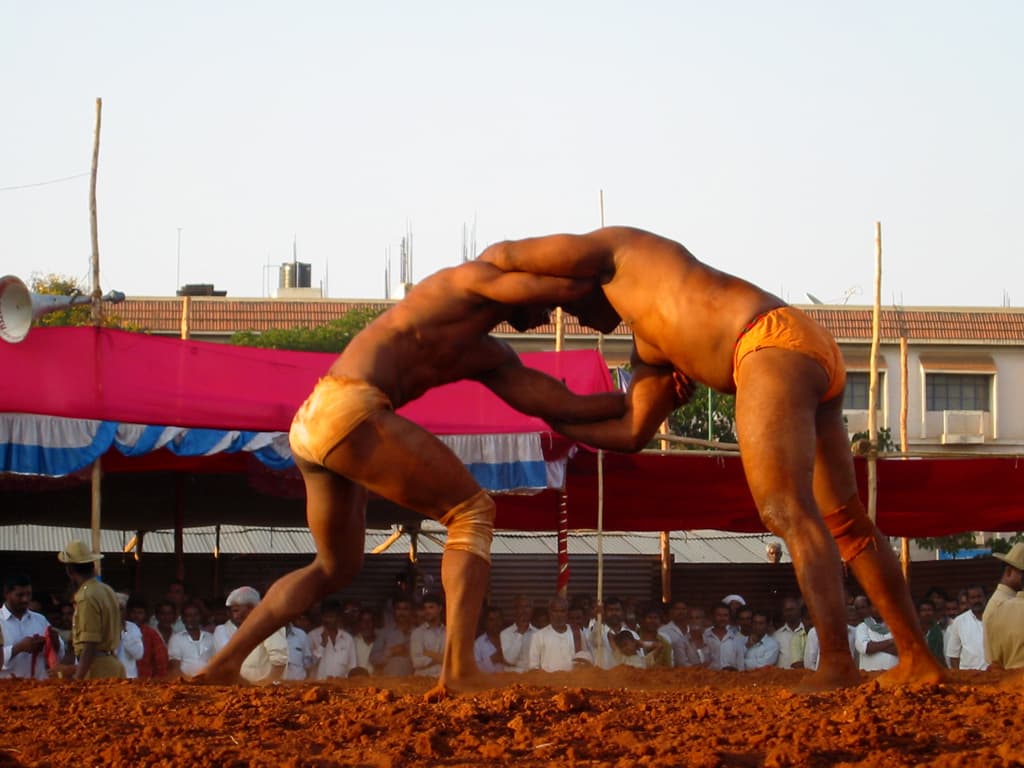 Traditional wrestlers in a grappling clinch